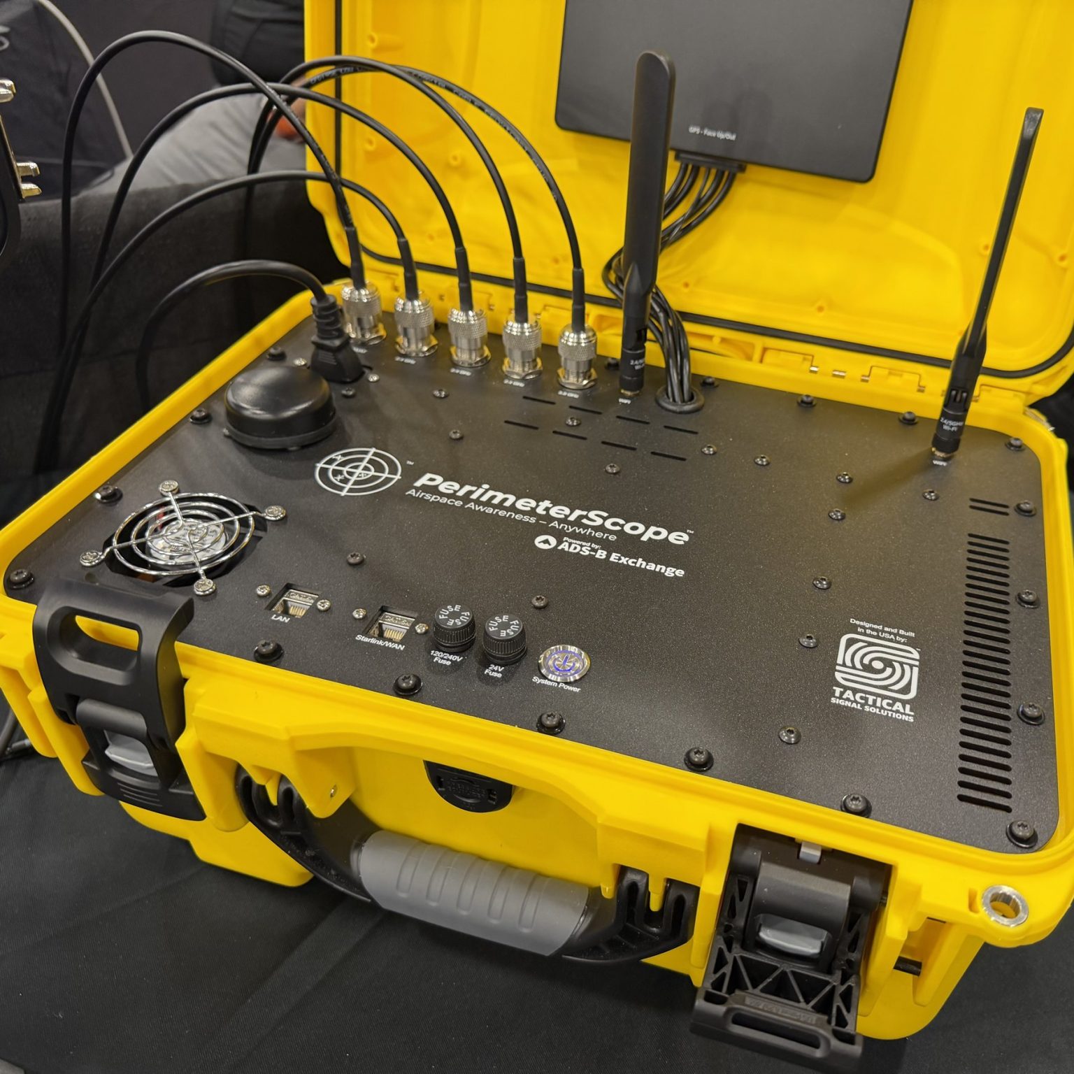 PerimeterScope portable unit open in its yellow rugged case, showing antenna connectors, LAN and Starlink ports, fuses and power button